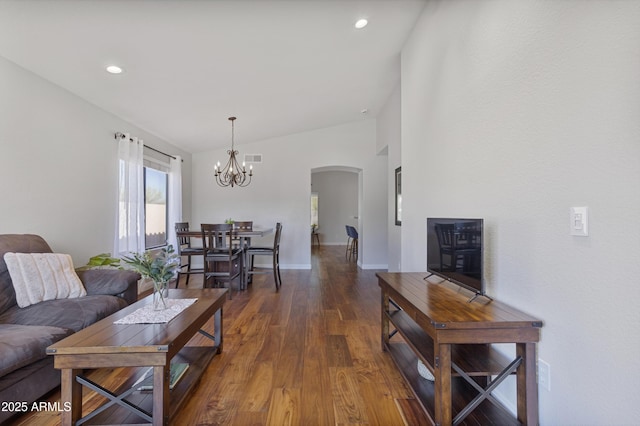 living room with arched walkways, wood finished floors, a chandelier, lofted ceiling, and recessed lighting