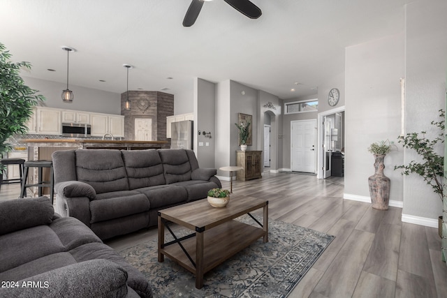 living room with sink, ceiling fan, and hardwood / wood-style floors