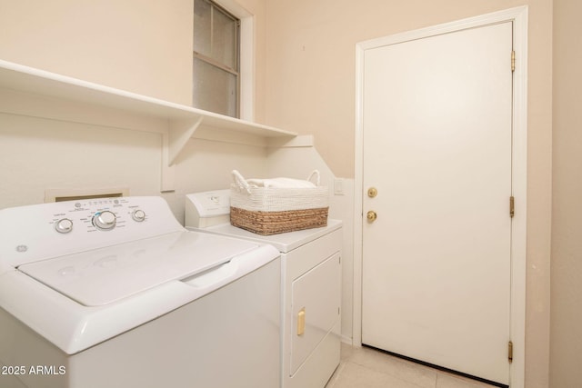 laundry area with light tile patterned floors and independent washer and dryer