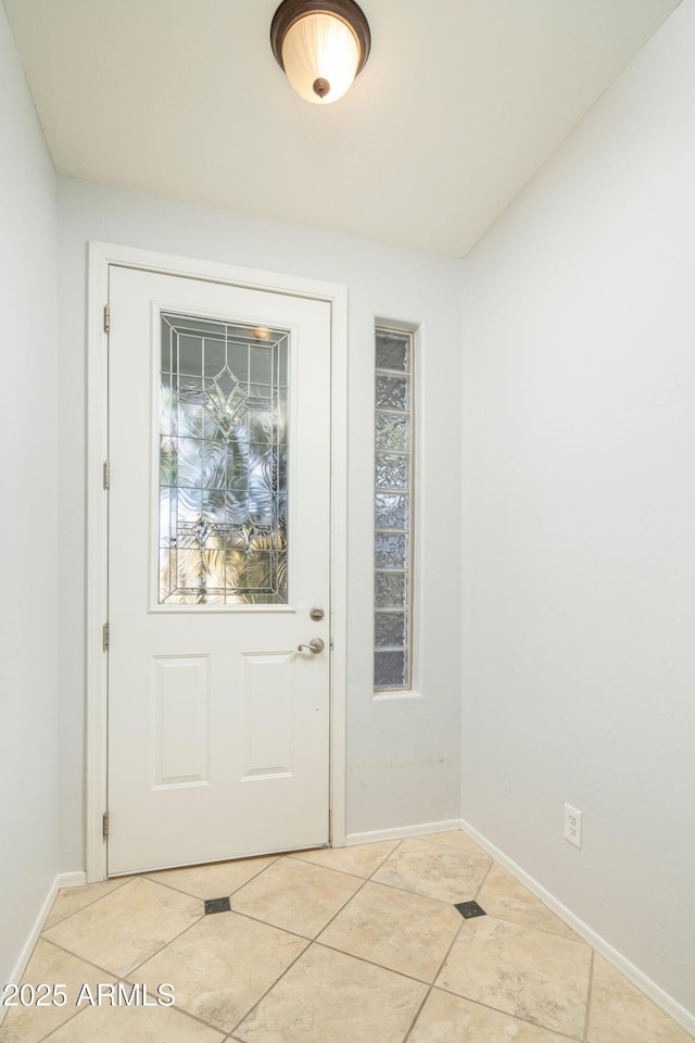 entryway with light tile patterned floors