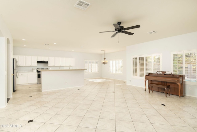 unfurnished living room with light tile patterned floors and ceiling fan with notable chandelier