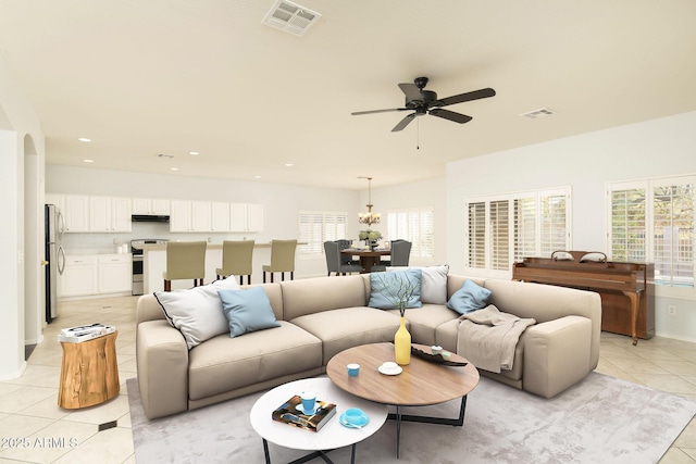 living room with light tile patterned flooring and ceiling fan