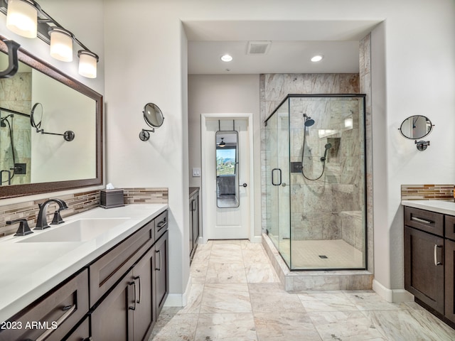 bathroom with vanity, backsplash, and walk in shower