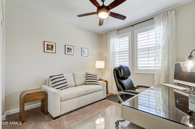 carpeted office space with ceiling fan