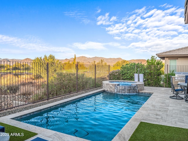 view of swimming pool featuring grilling area, a patio area, a mountain view, and an in ground hot tub