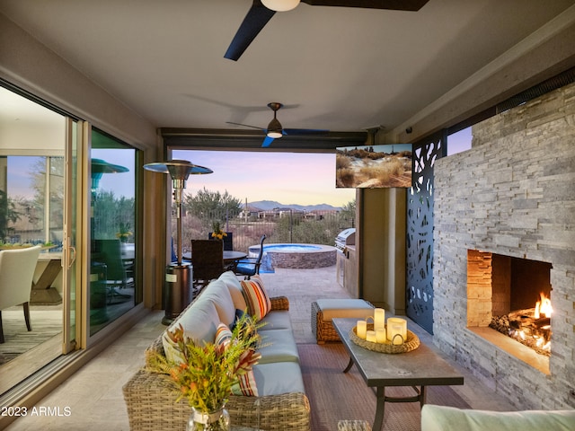 patio terrace at dusk featuring an outdoor living space with a fireplace