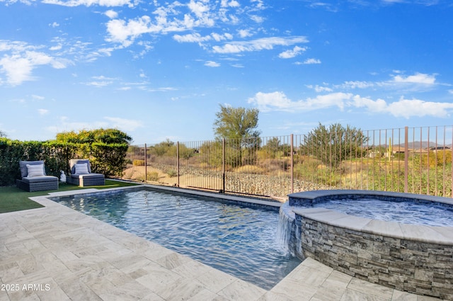 view of swimming pool featuring pool water feature, a patio, and an in ground hot tub