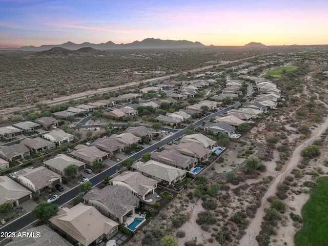 aerial view at dusk featuring a mountain view