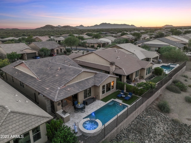 aerial view at dusk featuring a mountain view