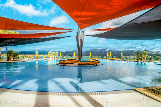 view of swimming pool with a mountain view