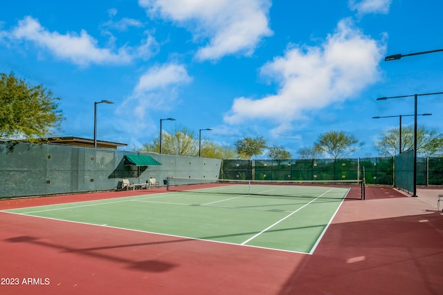 view of tennis court with basketball hoop