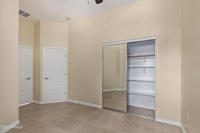 6202 E Mckellips Rd Unit 25, Mesa, AZ 85215 - unfurnished bedroom with a closet, baseboards, a ceiling fan, and tile patterned flooring