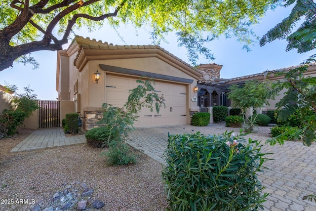 6202 E Mckellips Rd Unit 25, Mesa, AZ 85215 - mediterranean / spanish house with stucco siding, an attached garage, a tiled roof, and a gate
