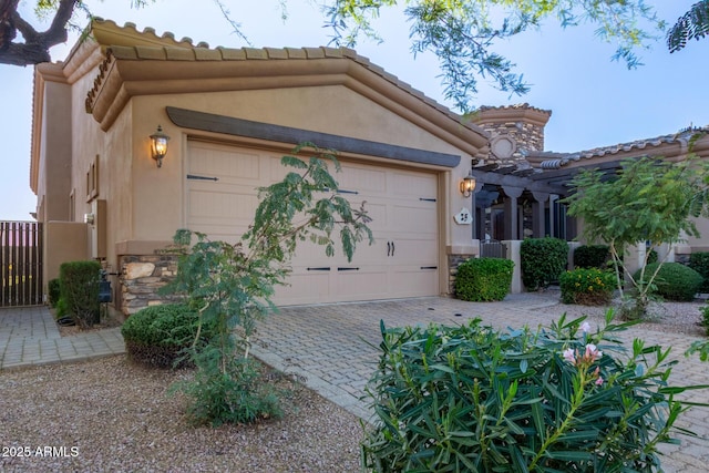 6202 E Mckellips Rd Unit 25, Mesa, AZ 85215 - view of front of home featuring a garage, a tiled roof, stucco siding, and driveway