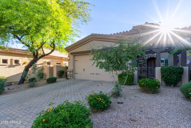 6202 E Mckellips Rd Unit 25, Mesa, AZ 85215 - view of front of home with stucco siding, driveway, an attached garage, and stone siding