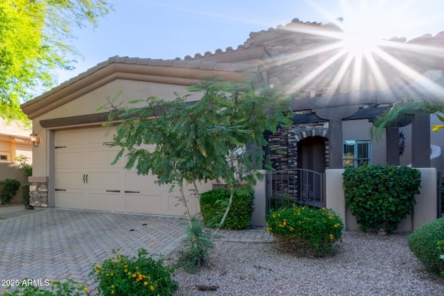 6202 E Mckellips Rd Unit 25, Mesa, AZ 85215 - view of front of home featuring stucco siding, driveway, stone siding, and a garage