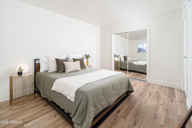 bedroom featuring a closet and light wood-type flooring