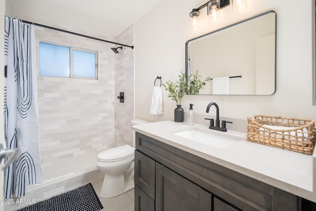 bathroom with a shower with curtain, vanity, tile patterned flooring, and toilet