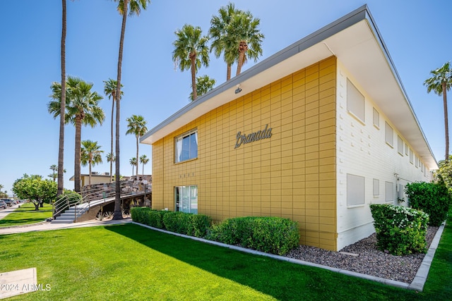 view of side of home featuring a lawn