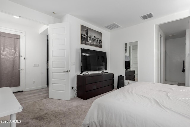 carpeted bedroom with baseboards and visible vents