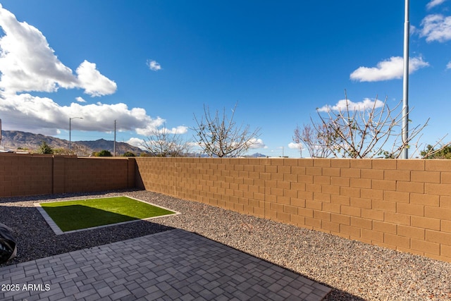 exterior space featuring a fenced backyard and a mountain view