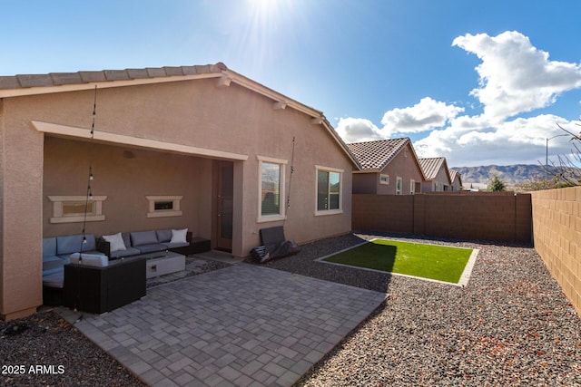 back of house featuring a fenced backyard, a patio, and stucco siding