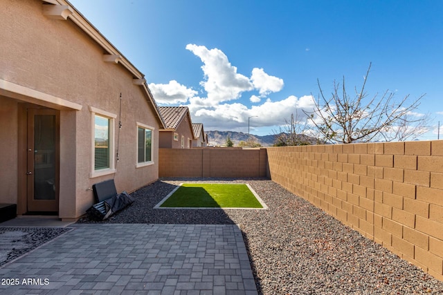 view of yard with a fenced backyard and a patio