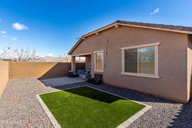 back of house featuring a patio area, a fenced backyard, a yard, and stucco siding