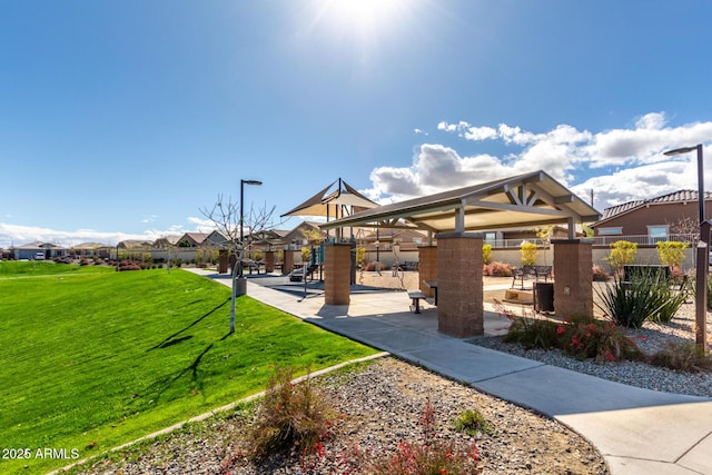 view of community with a residential view, a lawn, and a gazebo