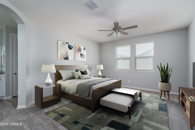 bedroom featuring arched walkways, baseboards, ceiling fan, and visible vents