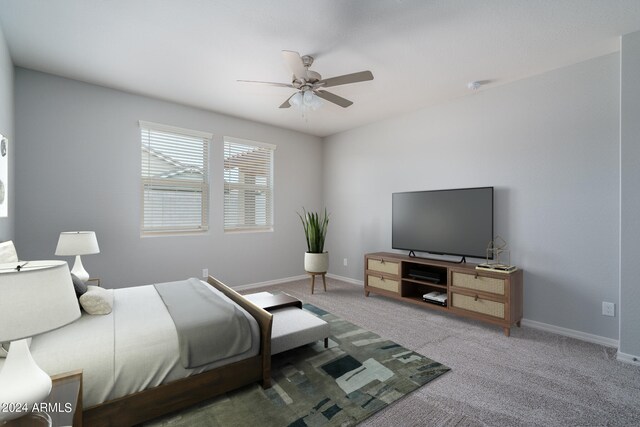 carpeted bedroom with baseboards and ceiling fan
