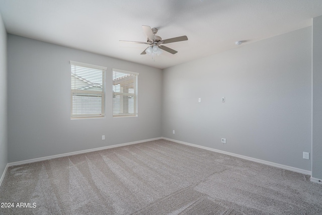 empty room featuring baseboards, ceiling fan, and carpet flooring