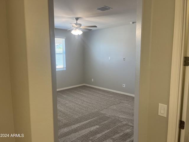 spare room with carpet and ceiling fan