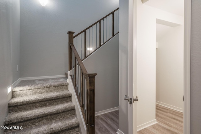 stairs featuring baseboards and wood finished floors