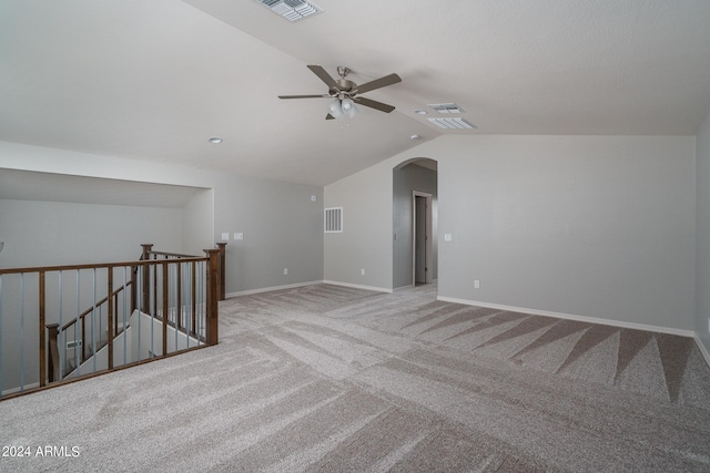 spare room featuring arched walkways, lofted ceiling, visible vents, and a ceiling fan