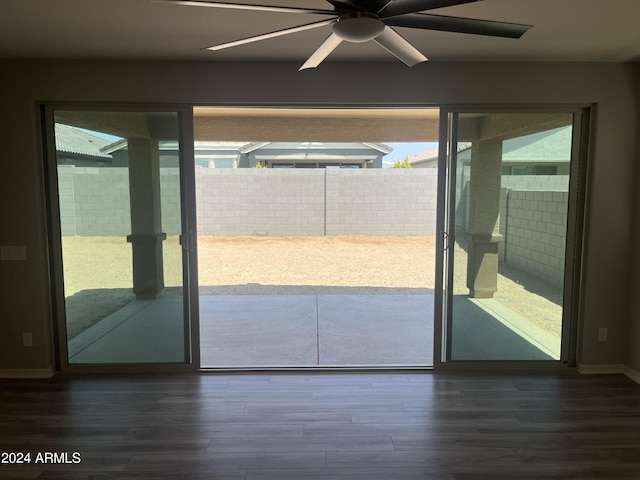 doorway with hardwood / wood-style floors, ceiling fan, and plenty of natural light