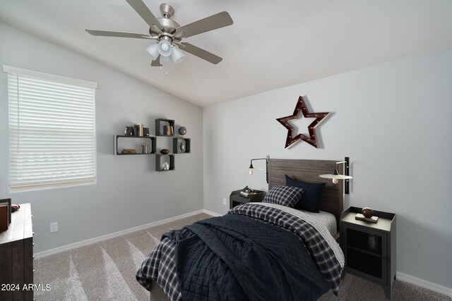 carpeted bedroom with baseboards, lofted ceiling, and a ceiling fan