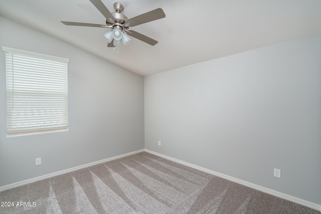 carpeted empty room with baseboards, lofted ceiling, and ceiling fan