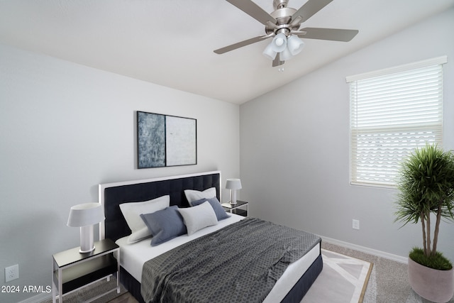 bedroom with baseboards, carpet floors, ceiling fan, and vaulted ceiling