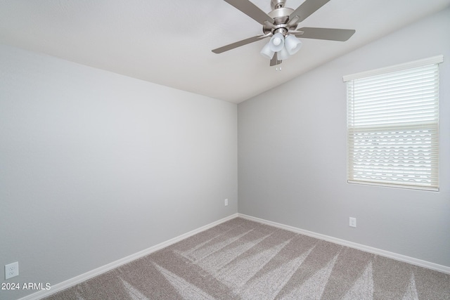 empty room featuring baseboards, carpet flooring, ceiling fan, and vaulted ceiling