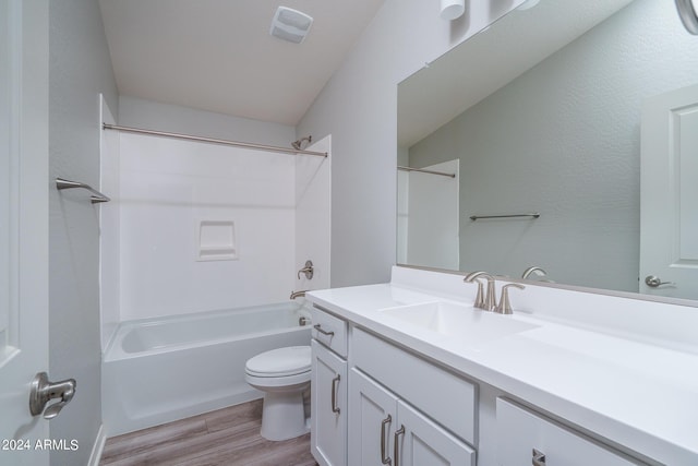 full bath featuring bathtub / shower combination, toilet, vanity, wood finished floors, and visible vents