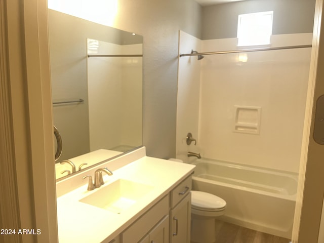 full bathroom with vanity, tub / shower combination, wood-type flooring, and toilet