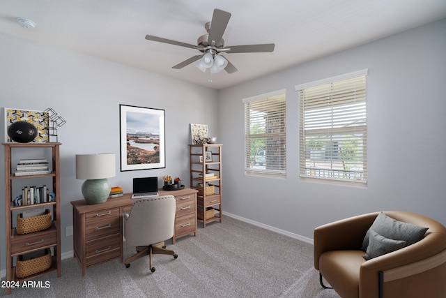 office with baseboards, a ceiling fan, and light colored carpet