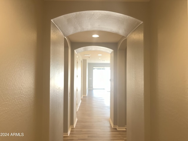 hallway with hardwood / wood-style floors