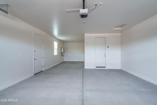 garage with a garage door opener and baseboards