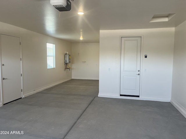 garage featuring a garage door opener and water heater