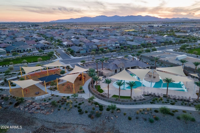 aerial view at dusk featuring a mountain view