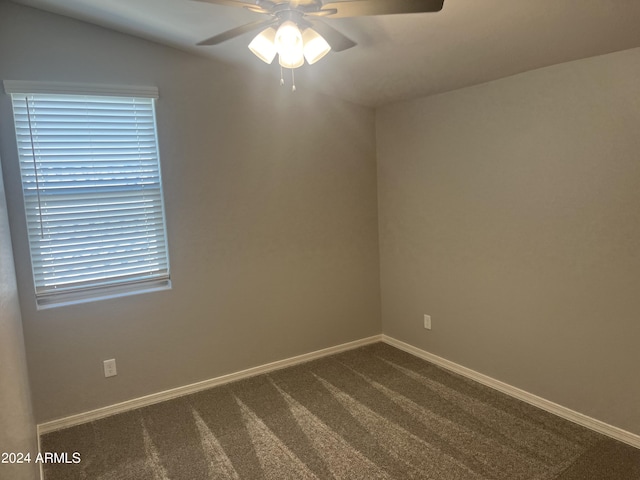 empty room featuring ceiling fan and carpet flooring