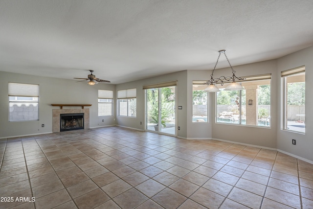 2340 W Myrtle Dr, Chandler, AZ 85248 - unfurnished living room featuring tile patterned floors, ceiling fan, a tile fireplace, and a textured ceiling