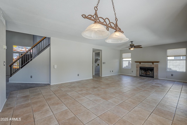 2340 W Myrtle Dr, Chandler, AZ 85248 - unfurnished living room featuring ceiling fan, light tile patterned floors, stairs, and a tiled fireplace
